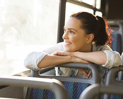 woman smiling on a bus 